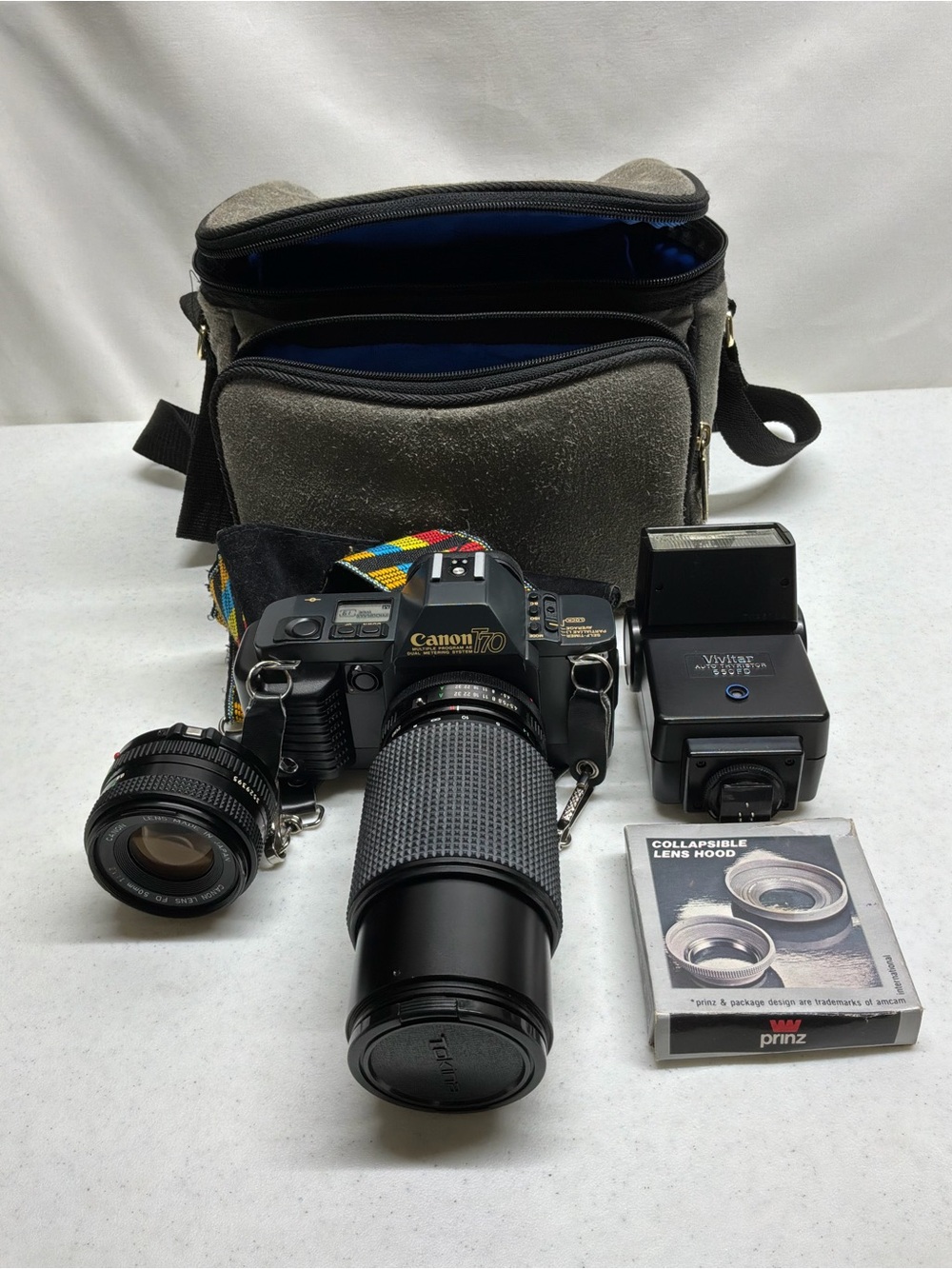 Canon T70 35mm SLR Camera with Black Telephoto Lens and Accessories